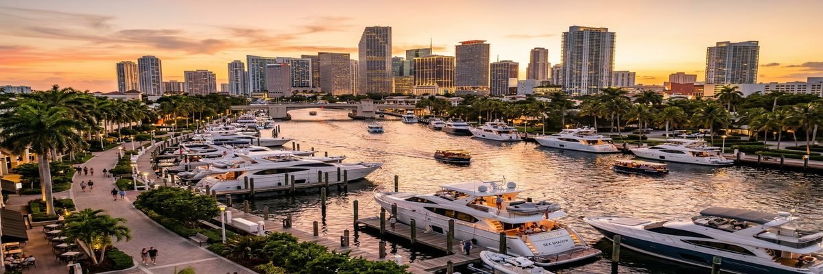 Fort Lauderdale, Florida New River with luxury yachts and downtown skyline at sunset